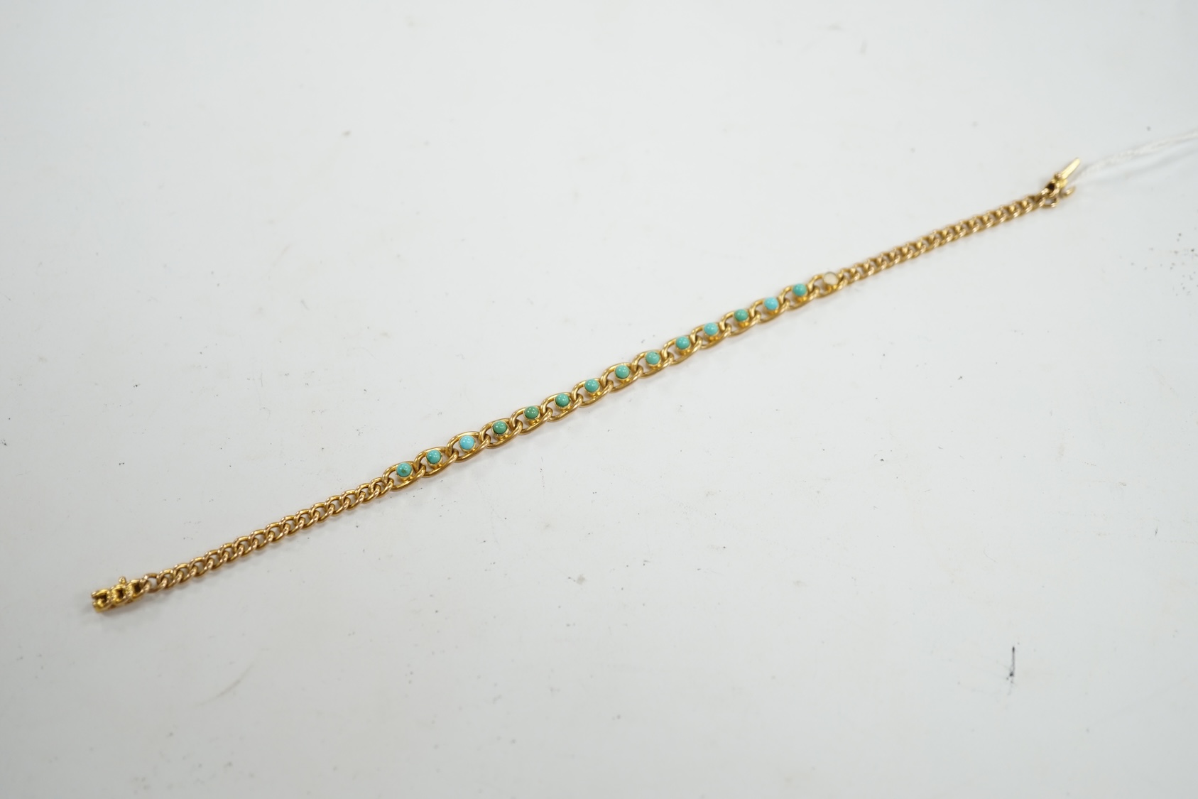 An Edwardian 15ct and turquoise set small curb and oval link bracelet, 17.5cm, stone missing, gross weight 8.1 grams. Condition - poor